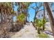 Charming path leading to the beach, framed by lush greenery and a glimpse of the house at 7475 Manasota Key Rd, Englewood, FL 34223