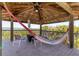 Relaxing tower featuring a hammock and seating area with scenic views of the surrounding landscape at 7475 Manasota Key Rd, Englewood, FL 34223