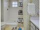 Bathroom featuring a walk-in shower, toilet, owl rug and floral wallpaper at 914 E 2Nd St, Englewood, FL 34223