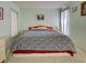 Bedroom with a large bed, plush carpet, and soft green walls at 914 E 2Nd St, Englewood, FL 34223