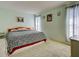 Bedroom with a large bed, plush carpet, and soft green walls at 914 E 2Nd St, Englewood, FL 34223