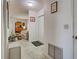 Hallway leading into a living room with carpet and light walls at 914 E 2Nd St, Englewood, FL 34223