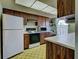 Functional kitchen with wood cabinets, white appliances, and an eat-in countertop at 914 E 2Nd St, Englewood, FL 34223