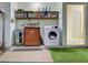 Functional laundry room with modern washer, vintage dryer, and shelving at 914 E 2Nd St, Englewood, FL 34223