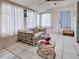 Sunroom featuring tile flooring, curtains, ceiling fan and rattan table at 914 E 2Nd St, Englewood, FL 34223
