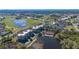 Aerial view of the complex showcasing the pool, lakes, and surrounding golf course at 10045 Links Ln # 203, Rotonda West, FL 33947