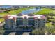 Panoramic aerial view of the building showing the landscaped grounds, water views, and golf course at 10045 Links Ln # 203, Rotonda West, FL 33947