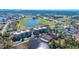 Scenic aerial view of condos, golf course, and lake offering an overview of the community at 10045 Links Ln # 203, Rotonda West, FL 33947