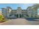 Beautiful condominium building featuring manicured landscaping and a stylish architectural design at 10045 Links Ln # 203, Rotonda West, FL 33947