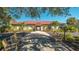 Exterior view of a community clubhouse with covered entry and meticulously maintained landscaping at 10045 Links Ln # 203, Rotonda West, FL 33947