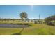 Scenic view of a golf course with a lush green landscape and tranquil pond at 10045 Links Ln # 203, Rotonda West, FL 33947
