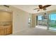 Bright living area with wet bar that opens to a screened balcony with golf course views at 10045 Links Ln # 203, Rotonda West, FL 33947