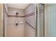 Shower with glass door shows tile surround and updated shower head at 10045 Links Ln # 203, Rotonda West, FL 33947