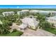 Aerial view of community clubhouse, pool, and other community buildings surrounded by palm trees and landscaping at 10360 Longshore Rd # 66, Placida, FL 33946