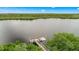 Aerial view showcasing a dock and floating platform surrounded by lush greenery and calm waters at 10360 Longshore Rd # 66, Placida, FL 33946