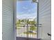 View from Balcony, showcasing a quiet street with townhomes and palm trees at 10360 Longshore Rd # 66, Placida, FL 33946