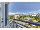 Balcony overlooking landscaped community with palm trees, sidewalks, and residences at 10360 Longshore Rd # 66, Placida, FL 33946