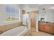 Luxury bathroom features large soaking tub, glass enclosed shower and beautiful window view at 10360 Longshore Rd # 66, Placida, FL 33946