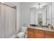 Bathroom includes granite countertop vanity and walk-in shower with a blue striped curtain at 10360 Longshore Rd # 66, Placida, FL 33946