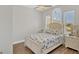 Bright bedroom with a large window, neutral walls, and a coastal-themed bedspread at 10360 Longshore Rd # 66, Placida, FL 33946