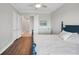 Spacious bedroom with wood floors, large closet doors and view of an extended hallway at 10360 Longshore Rd # 66, Placida, FL 33946