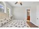 Bright bedroom with a large window, neutral walls, and a coastal-themed bedspread at 10360 Longshore Rd # 66, Placida, FL 33946