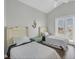 Bright bedroom featuring two twin beds, high ceilings, and access to an outdoor balcony at 10360 Longshore Rd # 66, Placida, FL 33946