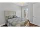 Well-lit bedroom features a queen bed, and balcony with a view at 10360 Longshore Rd # 66, Placida, FL 33946