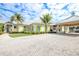 Charming community clubhouse with a covered entrance, lush landscaping and ample parking at 10360 Longshore Rd # 66, Placida, FL 33946