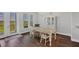 Dining room featuring wood floors, glass-top table, and a bright window with a scenic view at 10360 Longshore Rd # 66, Placida, FL 33946