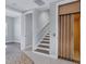 Hallway featuring an elevator, stairs with stained wood steps, and tiled floors at 10360 Longshore Rd # 66, Placida, FL 33946