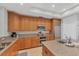 Spacious kitchen featuring granite countertops, stainless steel appliances, and wood cabinets at 10360 Longshore Rd # 66, Placida, FL 33946