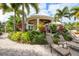 Lounge area poolside surrounded by tropical foliage and flowers, great for relaxing outdoors at 10360 Longshore Rd # 66, Placida, FL 33946