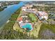 Stunning aerial view of community buildings, swimming pool, tennis courts, and waterfront at 11200 Hacienda Del Mar Blvd # 201, Placida, FL 33946