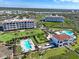 Aerial view of condo buildings, swimming pools, and landscaping in a well-planned community at 11200 Hacienda Del Mar Blvd # 201, Placida, FL 33946