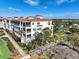 Multi-story condo building showcasing manicured grounds, mature trees, and walkways at 11200 Hacienda Del Mar Blvd # 201, Placida, FL 33946