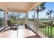 Spacious lanai with tile floors and wrought iron railing offers views of tropical foliage and a community pool at 11200 Hacienda Del Mar Blvd # 201, Placida, FL 33946
