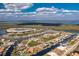 Scenic aerial view of waterfront homes with boat docks in a coastal community on a sunny day at 15626 Meacham Cir, Port Charlotte, FL 33981