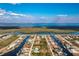 Stunning aerial view of waterfront homes with boat docks on a sunny day near a large bay at 15626 Meacham Cir, Port Charlotte, FL 33981