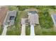 Aerial view of house showcasing large yard, driveway, and screened pool at 215 Australian Dr, Rotonda West, FL 33947