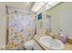 Bathroom with a single sink vanity and a shower with colorful curtain at 215 Australian Dr, Rotonda West, FL 33947