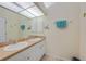 Bathroom featuring double sinks, a large mirror, and modern lighting at 215 Australian Dr, Rotonda West, FL 33947