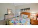 Comfortable bedroom with a dresser, nightstands, and a colorful quilt at 215 Australian Dr, Rotonda West, FL 33947