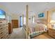 Spacious bedroom featuring a four-poster bed, carpet, and ample natural light at 215 Australian Dr, Rotonda West, FL 33947