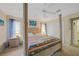 Bright bedroom with a four-poster bed, carpeted floor, and modern decor at 215 Australian Dr, Rotonda West, FL 33947