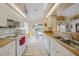 Bright kitchen view with stainless sink and breakfast nook overlooking the pool at 215 Australian Dr, Rotonda West, FL 33947