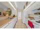 Galley kitchen boasts white cabinets, stainless sink, neutral countertops and stylish flooring at 215 Australian Dr, Rotonda West, FL 33947