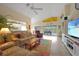 Bright and airy living room with tile floors and sliding doors to the screened-in pool at 215 Australian Dr, Rotonda West, FL 33947