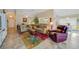 Inviting living room featuring neutral walls, tile flooring, and a colorful area rug at 215 Australian Dr, Rotonda West, FL 33947