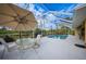 Outdoor dining area with an umbrella, and a view of the screened-in pool at 215 Australian Dr, Rotonda West, FL 33947
